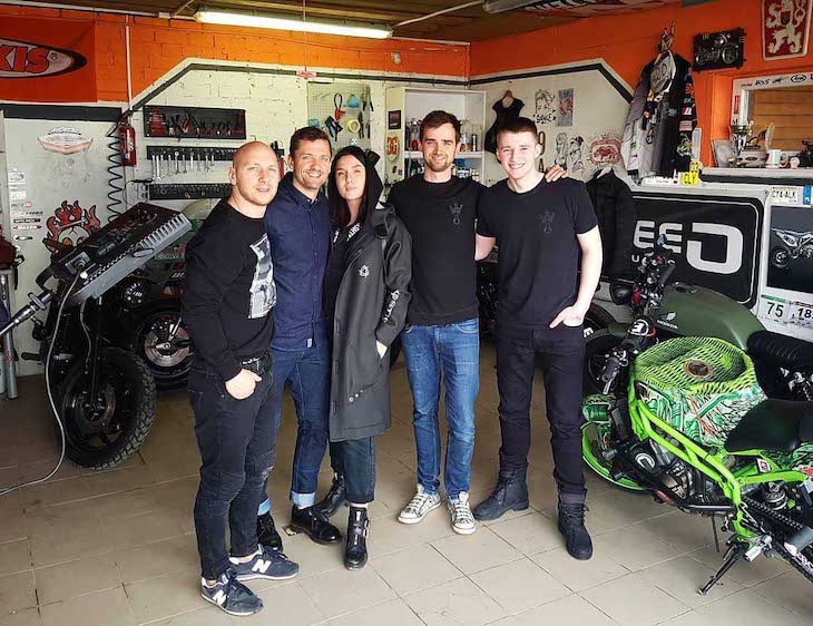 Pando Moto team and Paulius Labanauskas posing in store