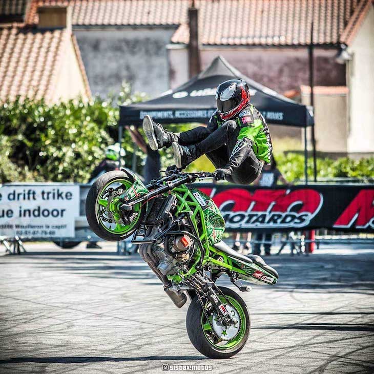 Paulius Labanauskas jumping on his bike's tank while holding grips