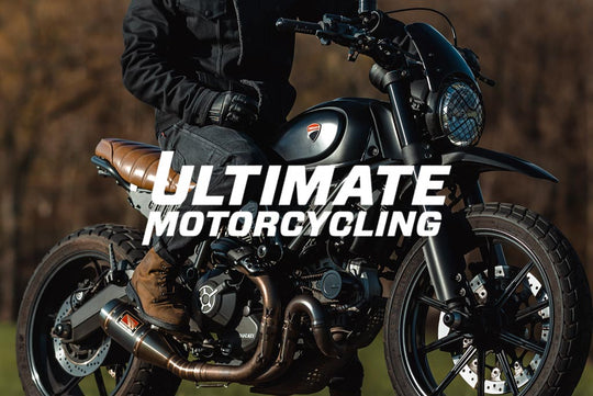 Motorcycle rider with Ultimate Motorcycling logo overlay—indicates external expert review of Boss Dyn 01 jeans.