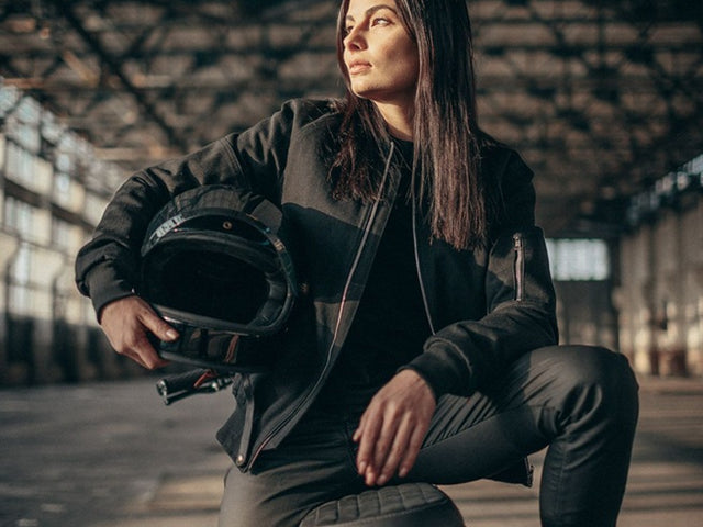 A rider wearing a stylish motorcycle jacket and jeans, illustrating the importance of choosing the right gear.