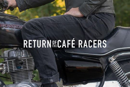 Close-up of Boss Dyn 01 riding jeans leg on café racer bike with ‘Return Of The Cafe Racers’ branding—emphasizes texture and context.