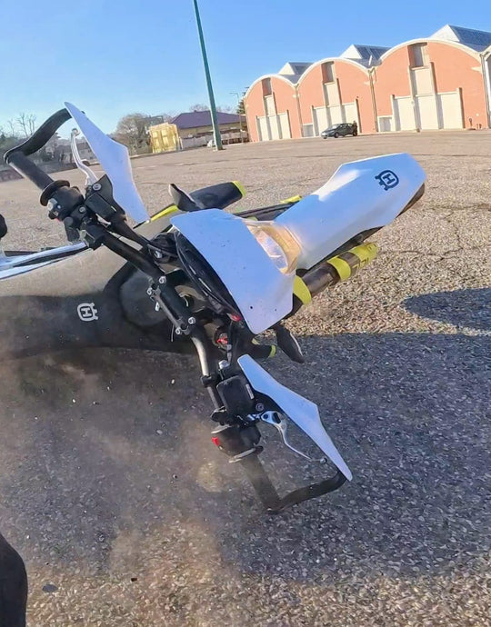 Motorcycle sliding out during failed wheelie.
