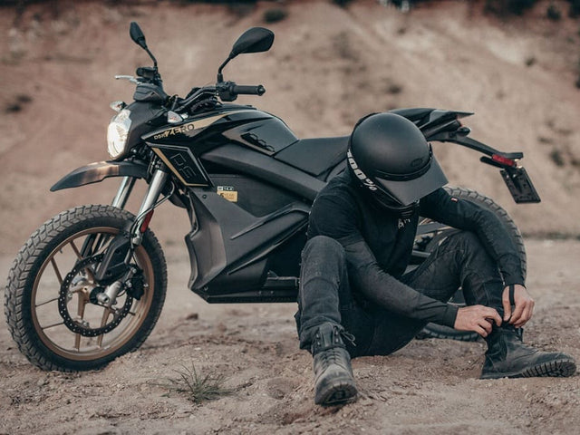A close-up of a rider's stylish leather motorcycle boots, highlighting the importance of proper protective footwear.