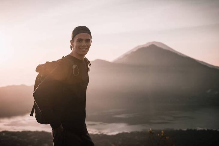 Bradlon Gworth posing in front of volcano in Bali