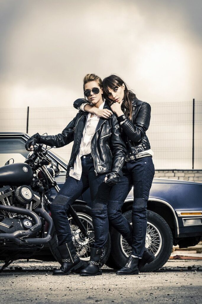Two biker women posing in motorcycle jeans