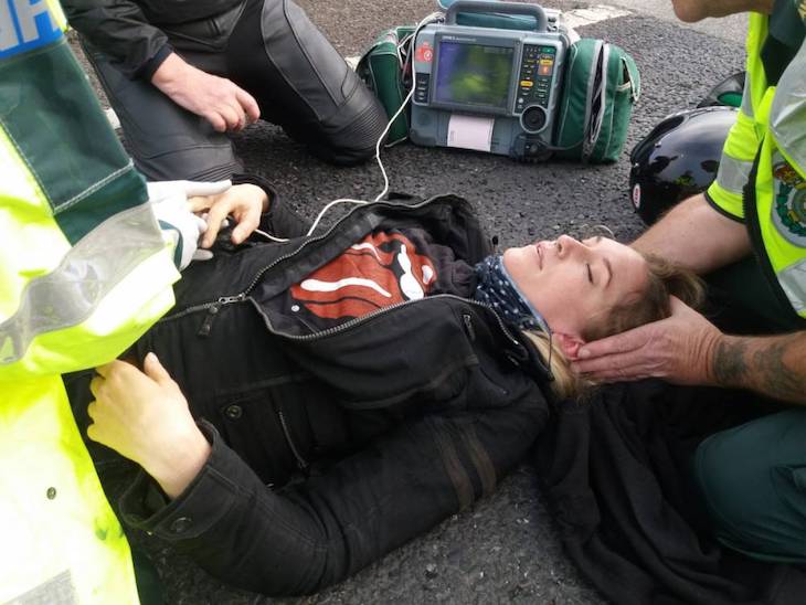 Biker lying on the ground after an accident without helmet