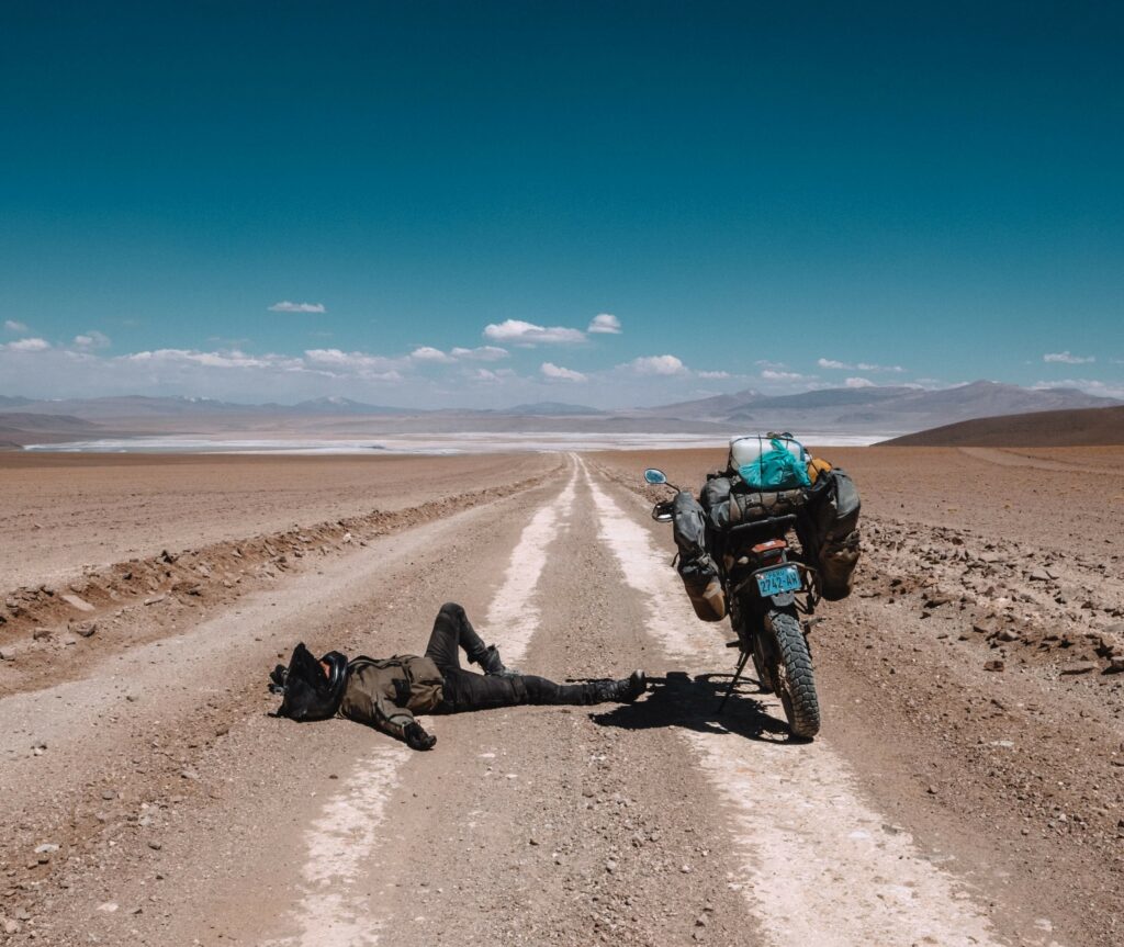 Tomas Adomavicius laying on the ground in the middle of a desert