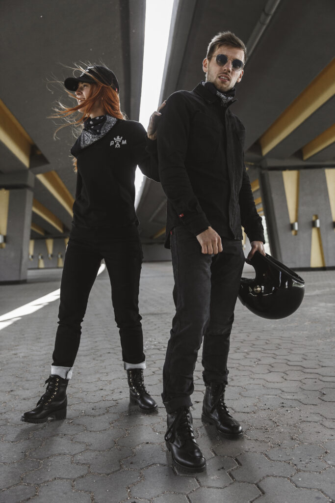 Biker couple in protective gear posing in full stance