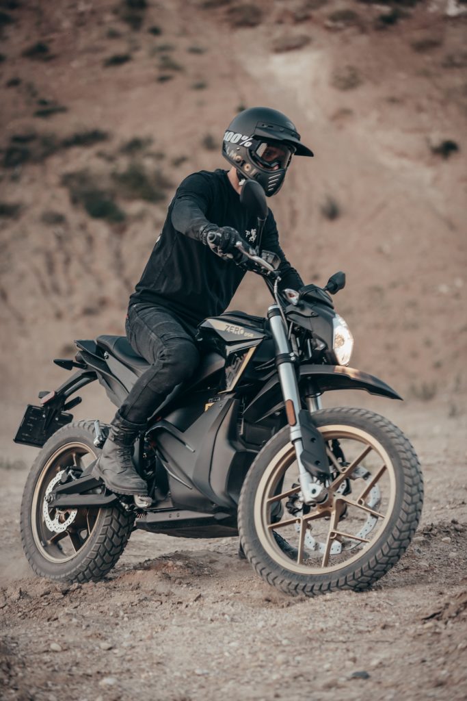 A motorcyclist in Dyneema jeans turning his dirt bike
