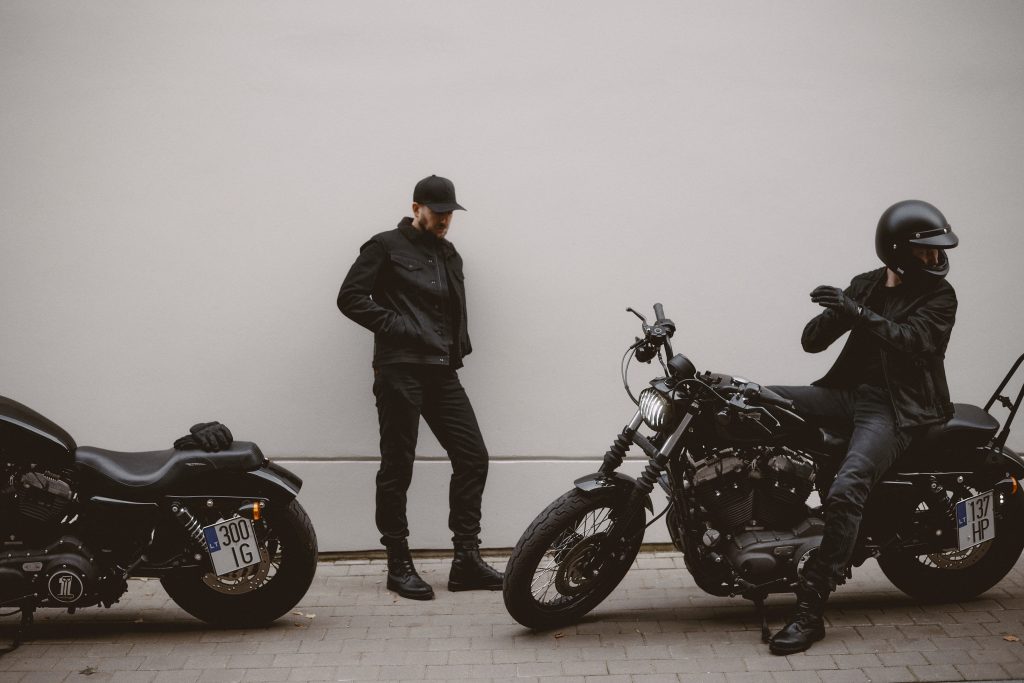 two men with motorcycles and gifts for motorcycle riders
