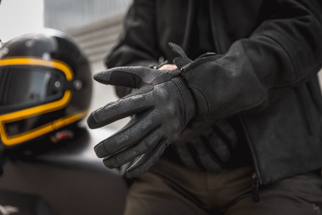 biker putting gloves and before learning how to ride a motorcycle 